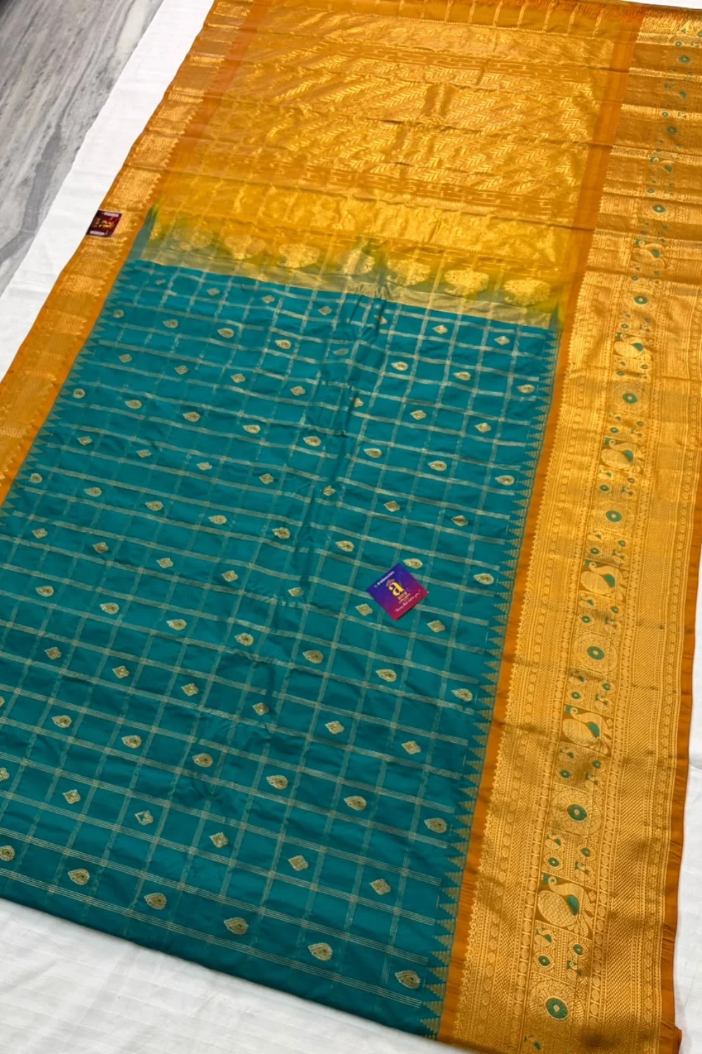 Peacock Blue Gadwal Semi Pattu Saree with checked body, zari butti motifs and mustard gold border